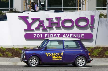 A man drives a Mini Cooper with a Yahoo! logo in front of Yahoo! headquarters in Sunnyvale, California, Feb. 1, 2008. Microsoft made a bid to buy Yahoo for $44.6 billion in cash and stock, seeking to join forces against Google in what would be the biggest Internet deal since the Time Warner-AOL merger.